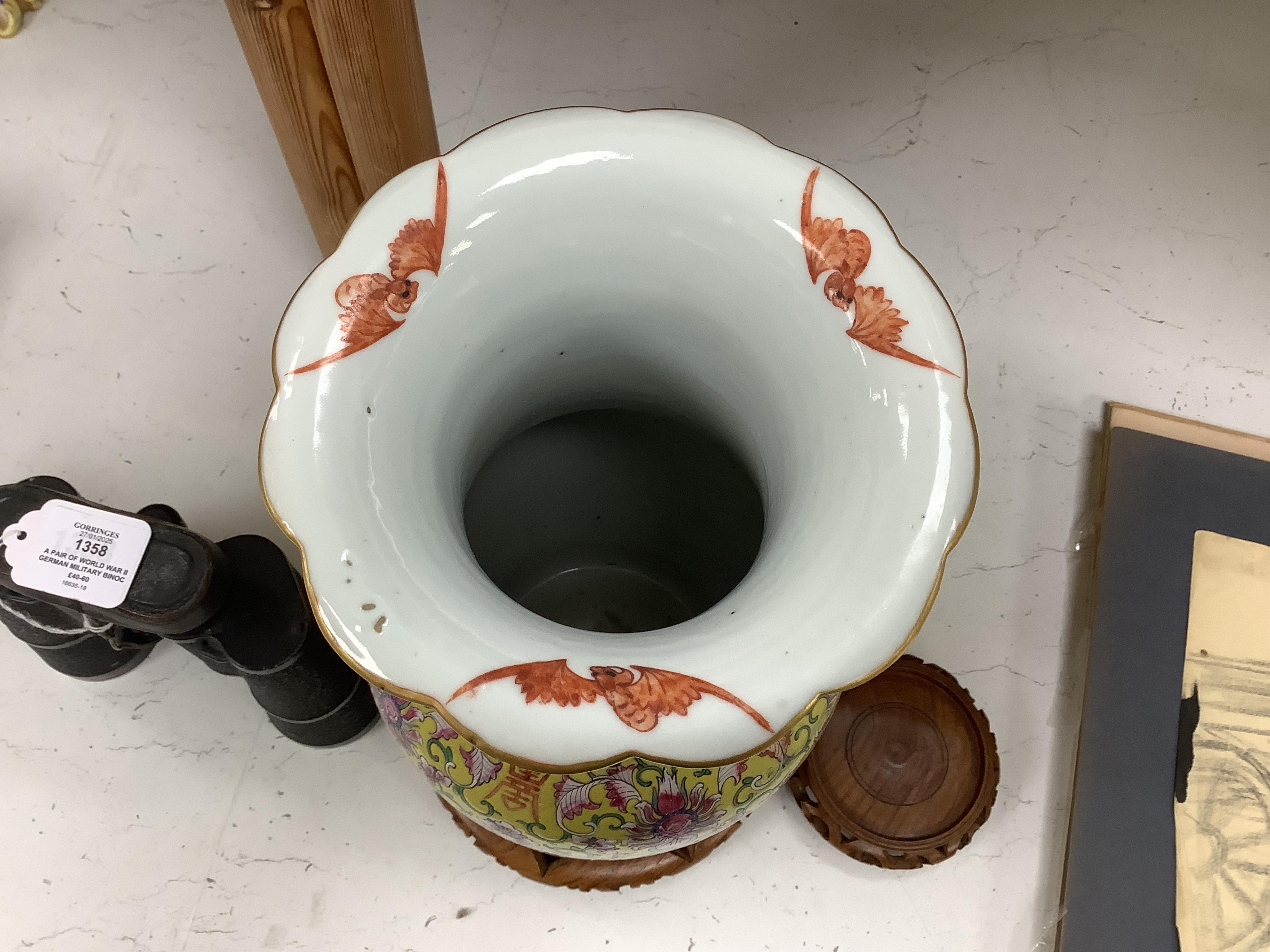 A late 19th century Chinese yellow ground porcelain vase, with gilt chilong handle, decorated with flowers and tendrils, iron red bands to the scalloped neck (including two stands), 35cm high. Condition - chip to top edg